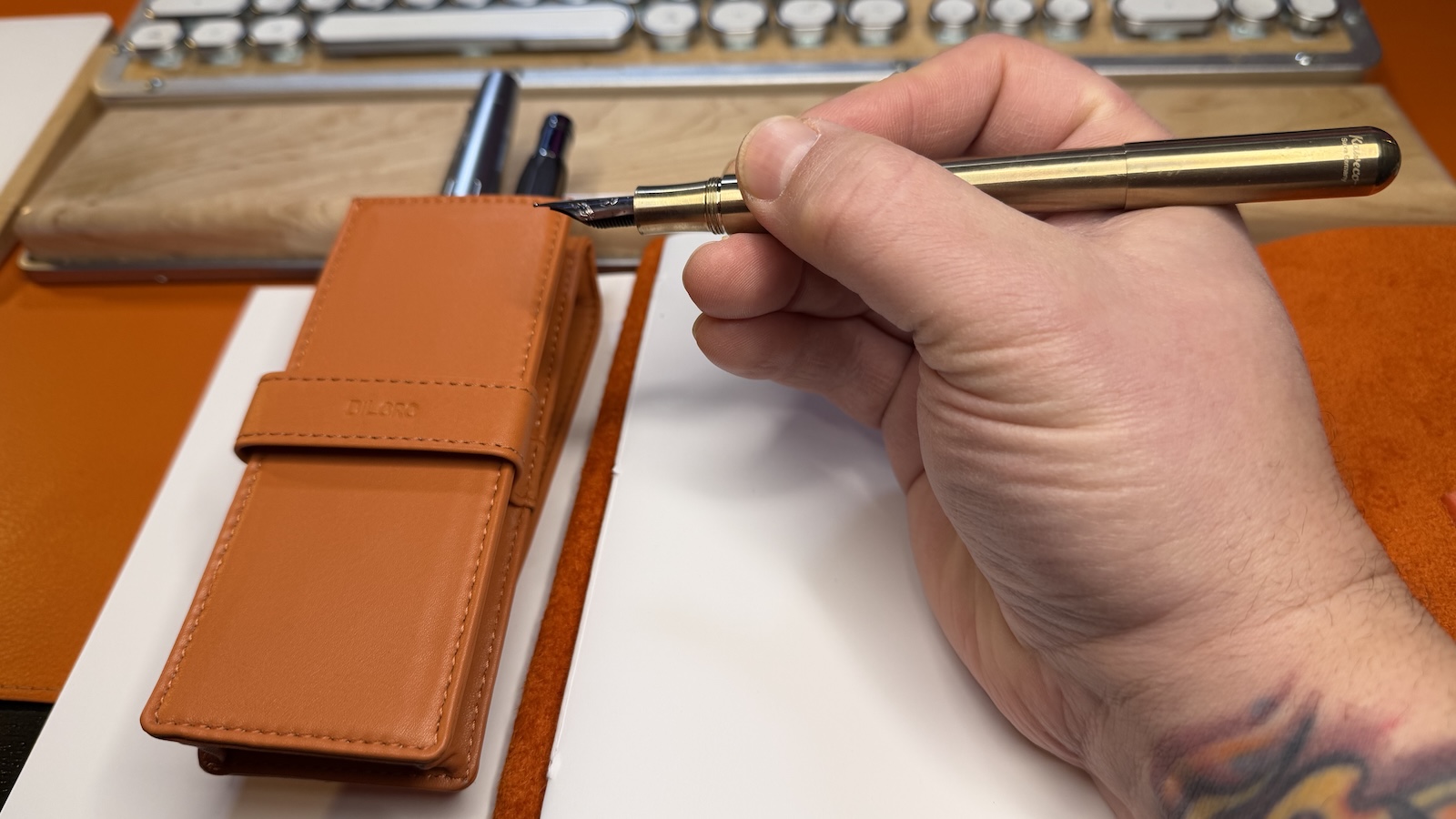 Kaweco-SUPRA-Brass-Open The Kaweco SUPRA Brass fountain pen uncapped in my hand to show the increased length when the cap is secured to the back of the barrel.