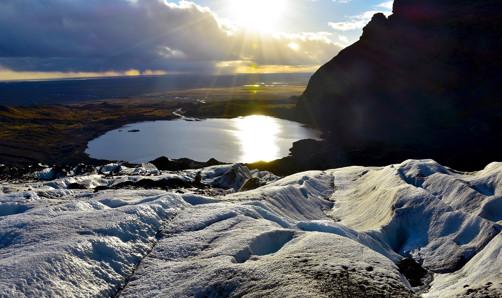 Reynisfjara A view from high on top of Skaftafell glacier looking towards a lake and a setting sun.