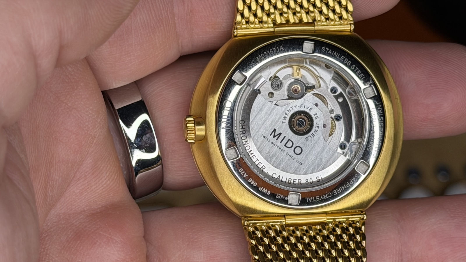 The transparent rear of the Mido Commander Ic&ocirc;ne's case showing the watch movement.