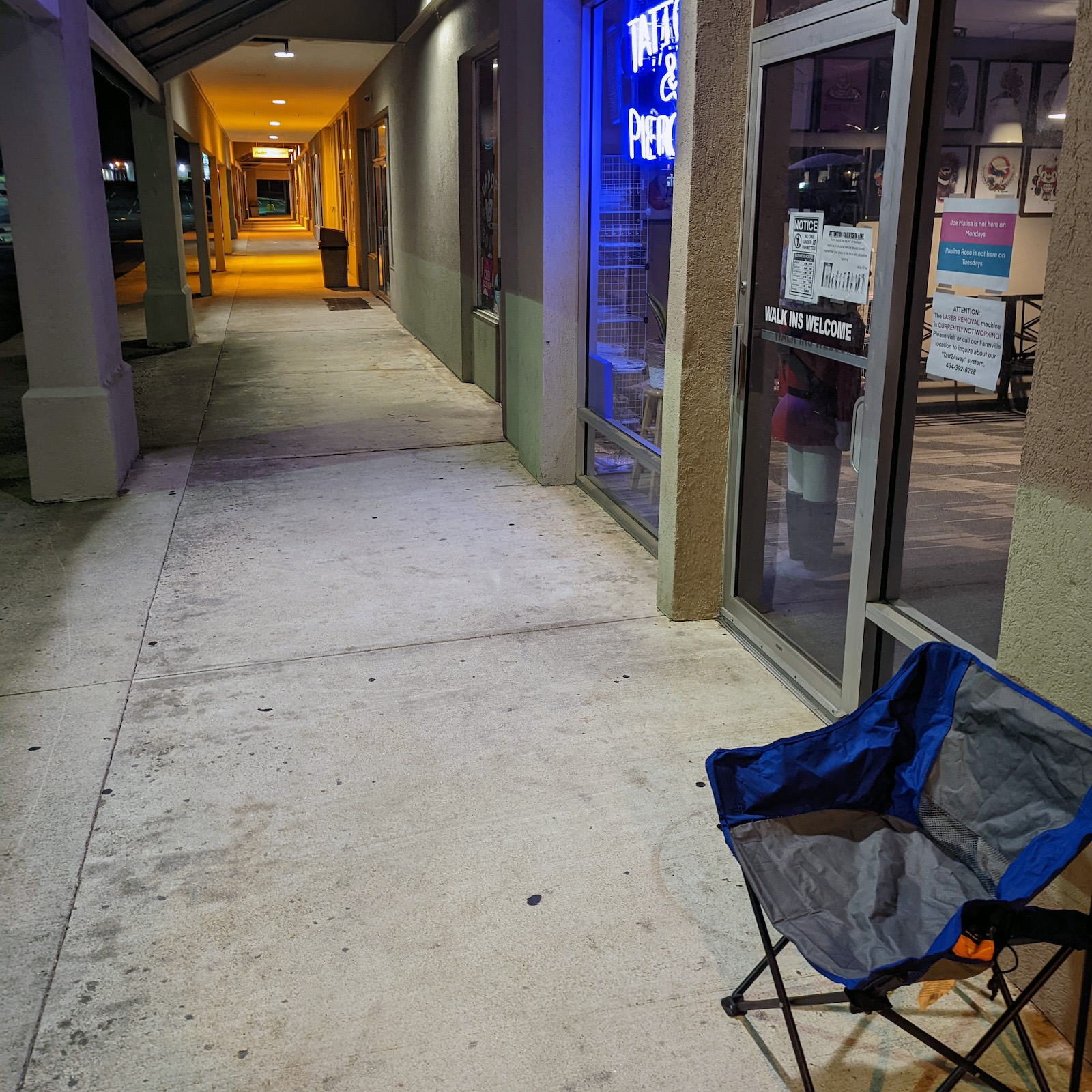 My camp chair is first in line outside of Kiss of Ink in Waterlick Plaza, Lynchburg, VA. The image was taken at 4:03 AM.