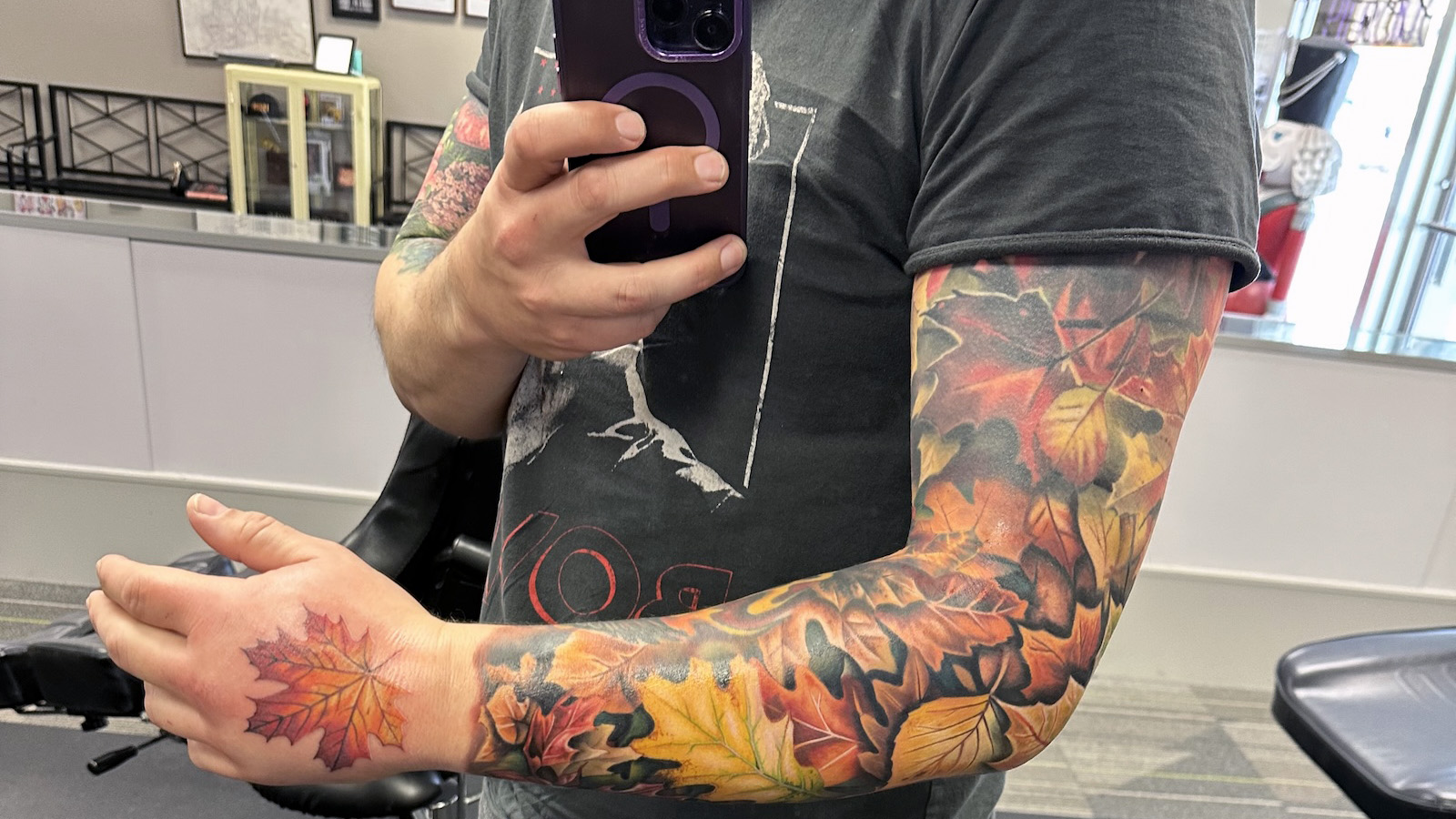 My finished right arm sleeve of autumn leaves, with an autumn maple leaf on my hand.