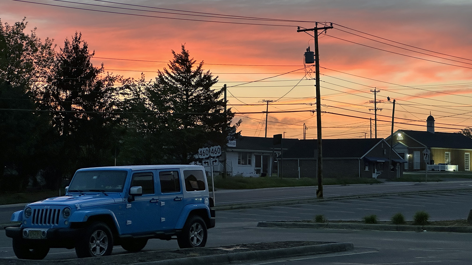 Sunrise over the Waterlick Plaza parking in Lynchburg, Virginia. My blue and white Jeep Wrangler Chief is in the lower left foreground
